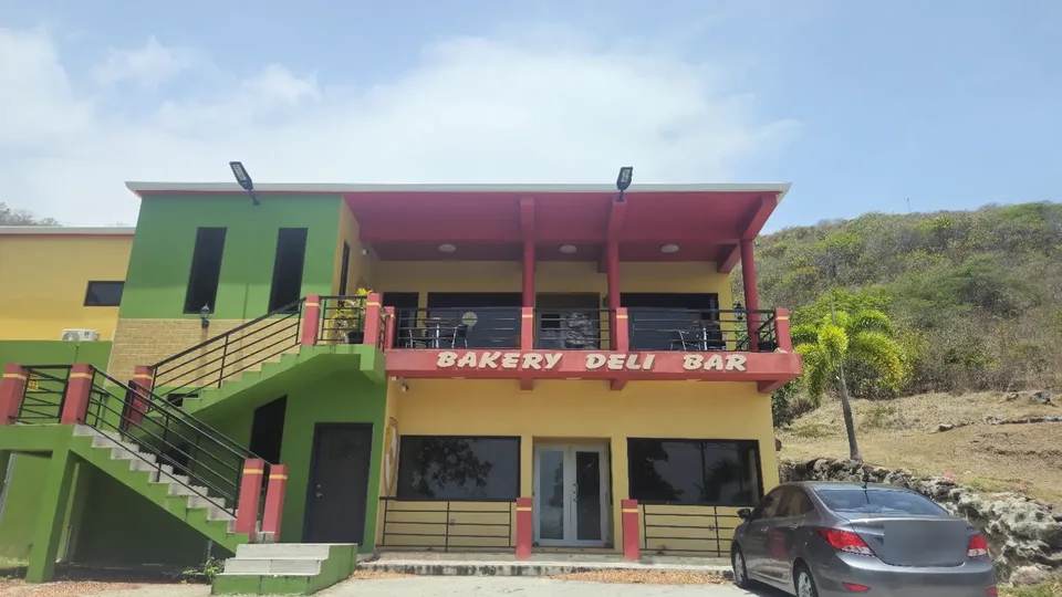 LBW Deli & Bar website homepage, showing the restaurant's hillside building in Potworks, Nevis