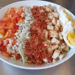 Instagram post from LBW Deli & Bar showing a Cobb salad with bacon, blue cheese, tomato, chicken, and egg
